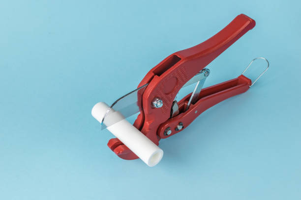 Red Pipe Cutter on Light Blue Background - Hand Tool for Cutting PVC Pipes