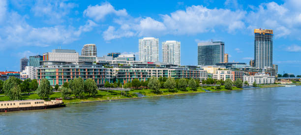 Bratislava, Slovakia - June 2022: Eurovea skyline, commercial and residential complex of buildings in downtown Bratislava; Apollo bridge over Danube river