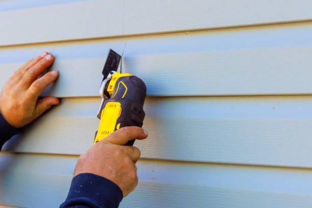 istock Damaged vinyl siding of house was removed using a multi tool during reconstruction 2155561239