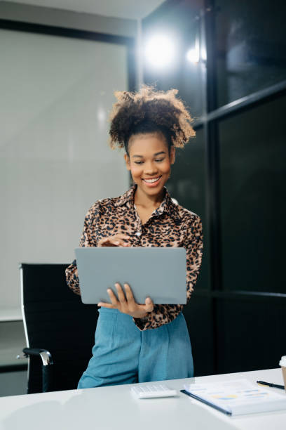 istock businesswoman working with working notepad, tablet and laptop documents talking on the smartphone, tablet 2155561971