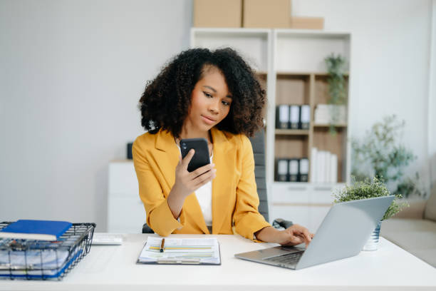 istock Confident woman with a smile standing holding notepad and tablet 2155562005