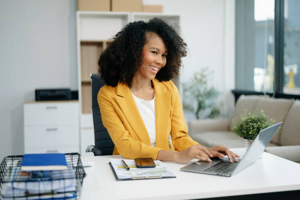istock Confident woman with a smile standing holding notepad and tablet 2155562016