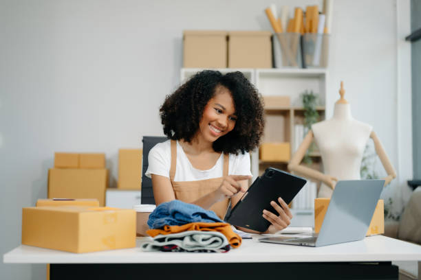 istock Asian young woman SME working using smartphone or tablet taking receive and checking online purchase shopping order 2155562026