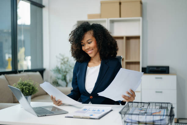 istock Confident woman with a smile standing holding notepad and tablet 2155562030
