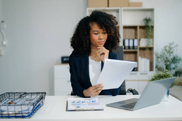 istock Confident woman with a smile standing holding notepad and tablet 2155562031