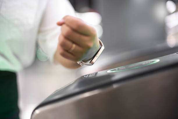 istock Young Asian woman using smart watch checking in at subway station 2155563934