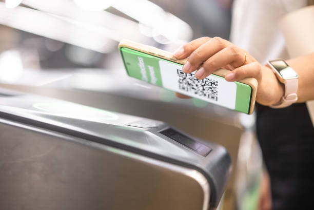 istock Young Asian woman using smartwatch checking in at subway station 2155563968