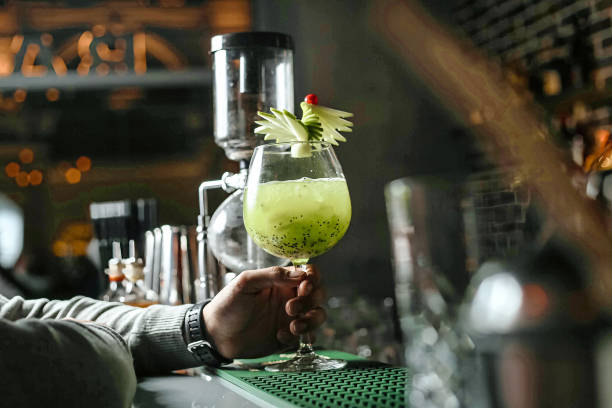 istock Person Holding a Drink in a Glass With Ice Cubes 2155566717