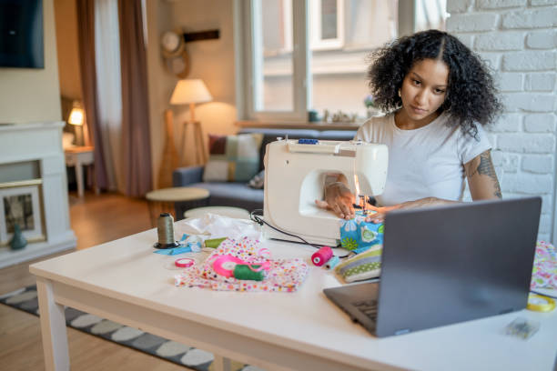 istock Woman learning to sew with online needlecraft course 2155567325