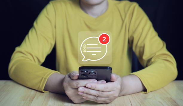istock Businessman using smartphone and laptop keyboard to chat.Technology, communication, Social media text messaging concepts. 2155567611