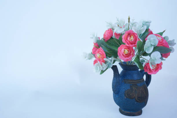 Artificial plants in flower pots made of earthenware. Space for text
