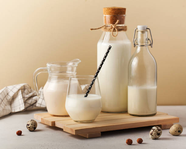 istock Various milk containers on a wooden board. Dairy product 2155571151