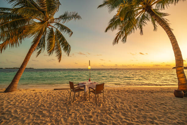 istock Enjoy romantic candlelight dinner on the tropical beach at sunset 2155573217