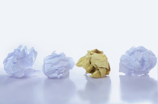 istock Be different concept. Yellow and white crumpled paper balls. Horizontal image. 2155574131