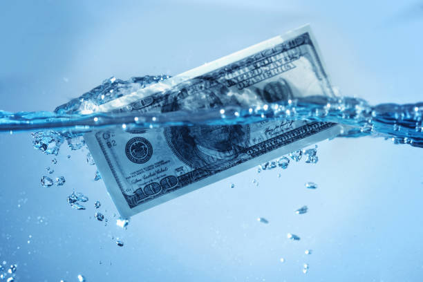 istock Global financiall crisis. US Dollar sinking in water 2155577720