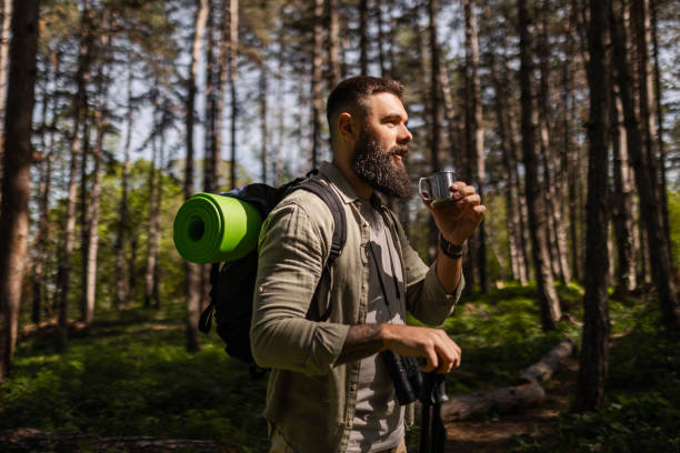 istock Hiker hiking in forest drinking coffee 2155579187