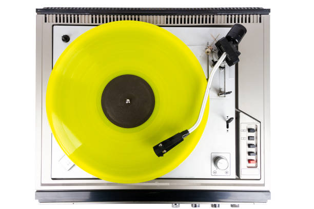 Vintage turntable record player with yellow vinyl isolated on white background.