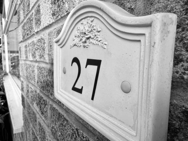 house number 38 in metal at white painted plaster wall in vintage style