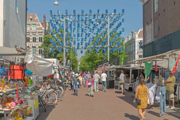 Amsterdam, Netherlands - May 15, 2018: Many People Walking at Flea Market Albert Cuypstraat Street Sunny Spring Day.