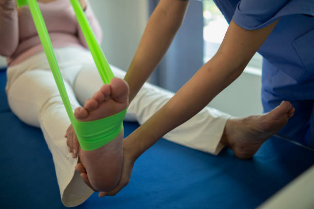 istock female doctor using elastic bands help patient regain muscle movement after recuperating from muscle injury and wants rehabilitate her be able use her normal daily life by practicing physical therapy 2155584521
