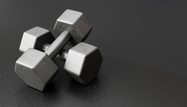 istock Grey dumbbells on black background.Stock photo 2155585181