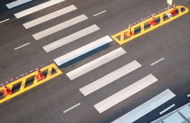 istock White crosswalk or crossing path on asphalt road aerial view background. 2155585942