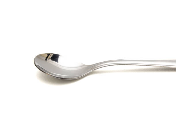 Large metal spoon in white background