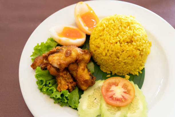 istock Chicken rice curry with coconut milk ( Koa Mook Gai). The dish features tender chicken, fluffy rice, and a variety of fresh vegetables. 2155589455