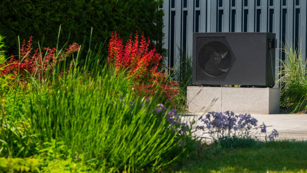 istock Heat pump unit installed near a pool surrounded by decorative plants. 2155590237
