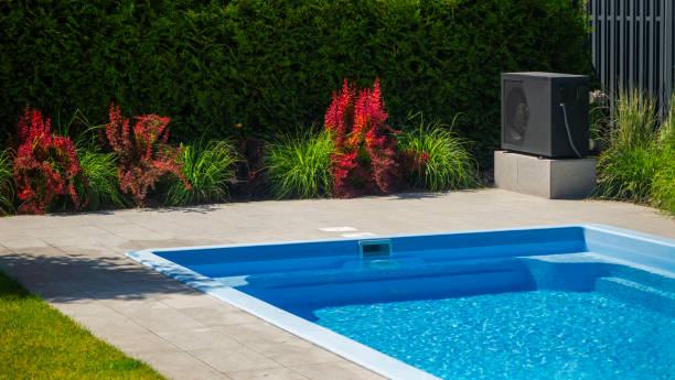 istock Heat pump unit by a pool with decorative plants around. 2155590460