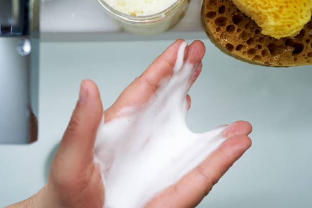 istock Foam cleanser in female hands over the sink. 2155590630