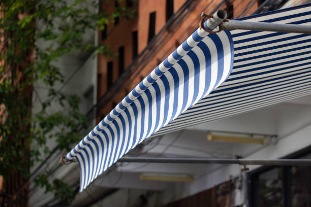 A blue and white striped awning is hanging over a building