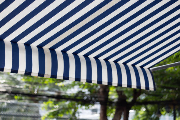 istock A blue and white striped canopy is hanging over a tree 2155592334