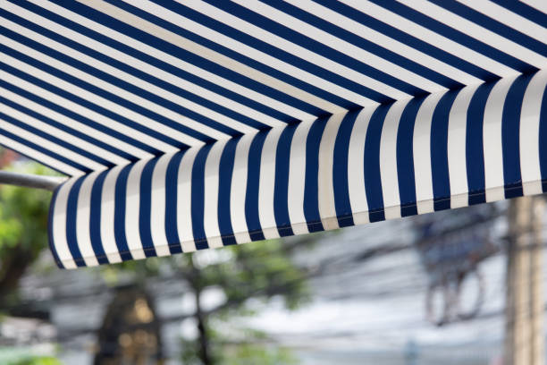 istock A blue and white striped awning is hanging over a tree 2155592336