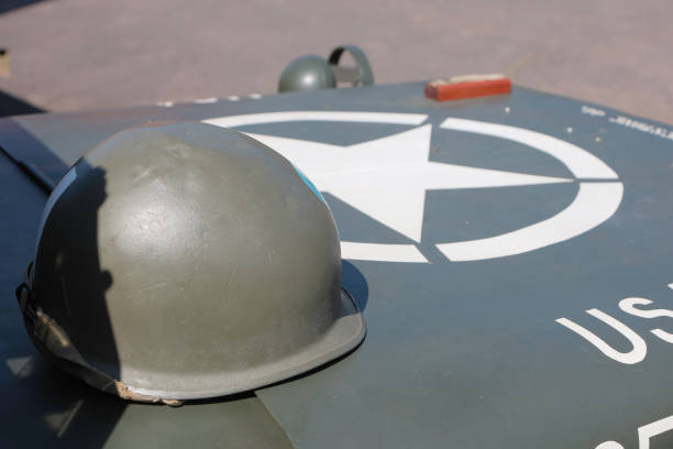 This image is of a US Army Issue ‘M1’ helmet resting on the bonnet of a US Willys Jeep in the sun. The large white star on the bonnet, or hood, of the jeep was to identify it to friendly aircraft.\n\nThis image was taken at a Living History and Military Vehicle experience over the week of 5th - 9th June 2023 at RAF Cosford, Wolverhampton, England. \n\nAn event where reenactors, living historians, and members of the public can come to experience what life was like during the second world war, with live demonstrations, battle reenactments, and static displays from all over the world.