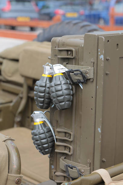 Explosives in hand. Military grenade. Weapons of mass destruction. Fragmentation grenade.