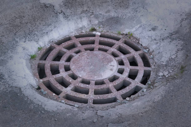istock Cast-iron manhole cover storm sewer. 2155592954