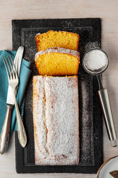 istock Orange fruit cake. Cake. Pound Cake. Traditional vanilla pound cake with orange. Orange loaf cake sliced on board. 2155593336