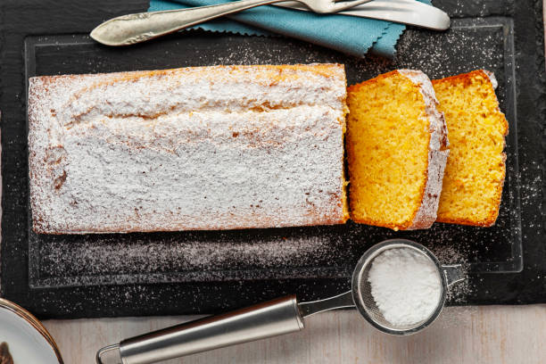 istock Orange fruit cake. Cake. Pound Cake. Traditional vanilla pound cake with orange. Orange loaf cake sliced on board. 2155593568