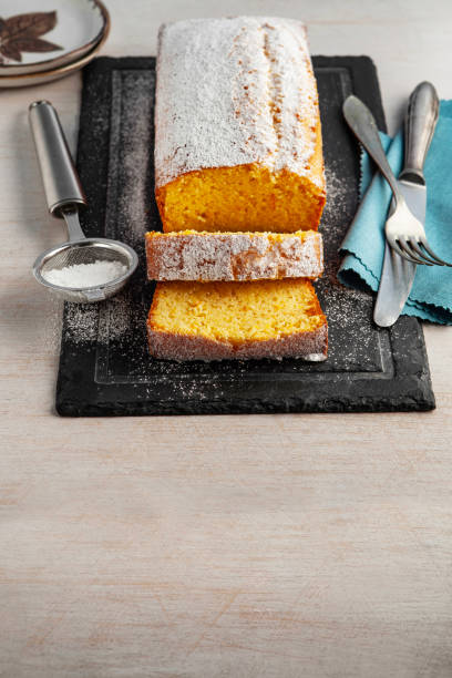 istock Orange fruit cake. Cake. Pound Cake. Traditional vanilla pound cake with orange. Orange loaf cake sliced on board. 2155594059