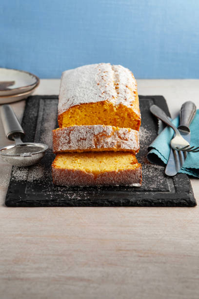 istock Orange fruit cake. Cake. Pound Cake. Traditional vanilla pound cake with orange. Orange loaf cake sliced on board. 2155594098
