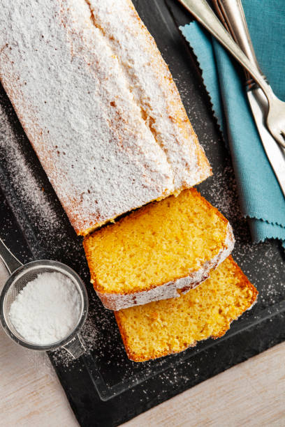 istock Orange fruit cake. Cake. Pound Cake. Traditional vanilla pound cake with orange. Orange loaf cake sliced on board. 2155594951