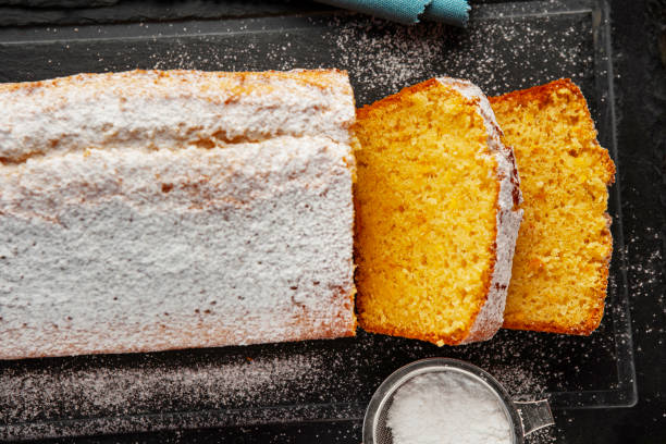 istock Orange fruit cake. Cake. Pound Cake. Traditional vanilla pound cake with orange. Orange loaf cake sliced on board. 2155595071