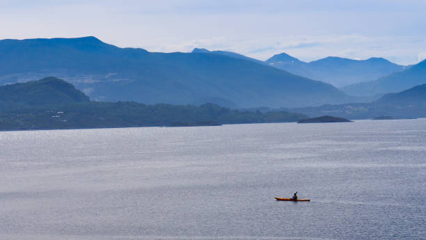 istock People kayaking on sea fjord 2155595271
