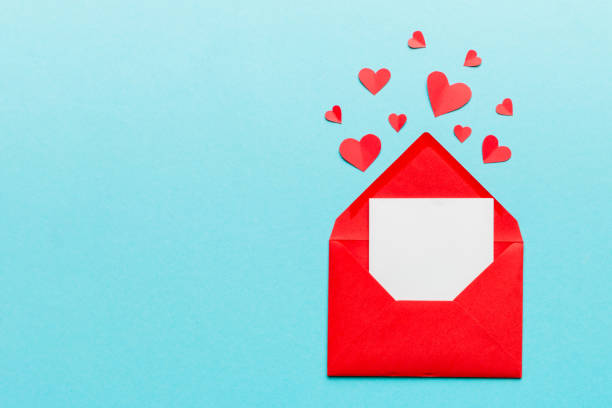 istock Red paper envelope with empty white card and heart on colored background. top view valentines day concept 2155595801