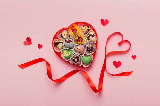 istock Valentine day composition: sweet candy, with gift boxes with bow and red felt hearts, photo template, background. Top View with copy space 2155595828