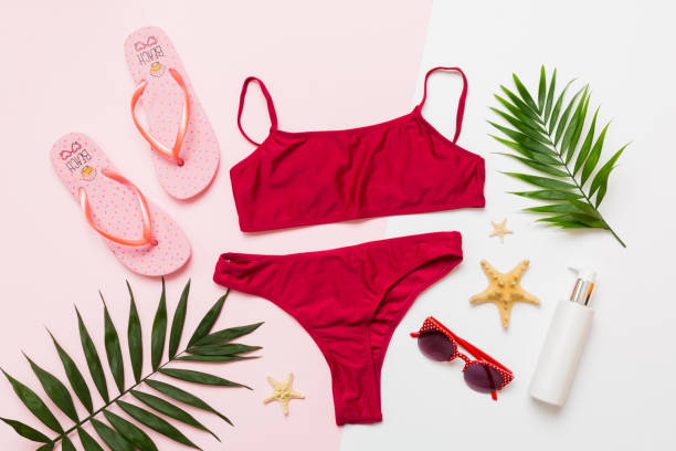 istock Traveler accessories, women summer bikini set swimsuit on table background with empty space for text. Travel vacation concept. Flat lay, top view Female sexy swimwear 2155595860