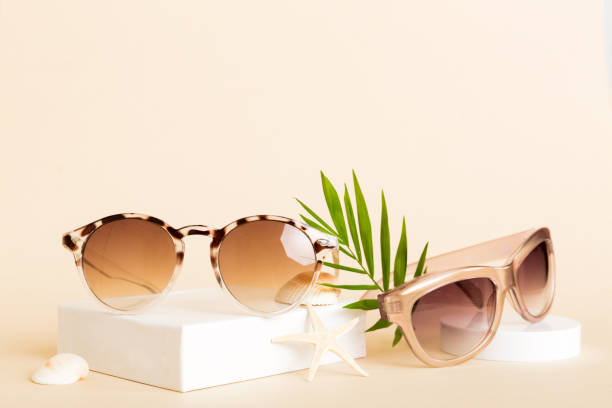 istock sunglasses with seashell lying on table background. Sunglasses on summer background. Top view flat lay with copy space for text 2155595870