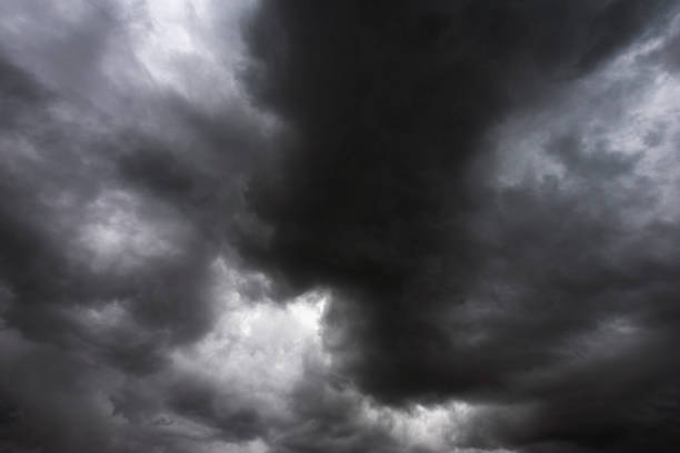 Dramatic dark storm rain clouds black sky background. Dark thunderstorm clouds rainny atmosphere. Meteorology danger windstorm disasters climate. Dark cloudscape storm disaster gloomy gray cloud sky