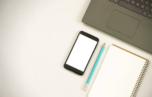 istock mobile phone with notebook and laptop on white background. 2155596811